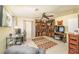 Spacious bedroom features a desk, seating area, ceiling fan and a display of cowboy boots at 10633 Tinta Ln, Las Vegas, NV 89144