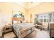 Bright bedroom with high ceilings, a decorative surfboard and a large window at 10633 Tinta Ln, Las Vegas, NV 89144