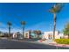 A community entrance with well-maintained landscaping and three palm trees at 10633 Tinta Ln, Las Vegas, NV 89144
