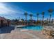 Relaxing community pool area with lounge chairs, shade structure and tall palm trees at 10633 Tinta Ln, Las Vegas, NV 89144