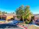 Charming single-story home featuring a well-maintained yard with mature tree and desert landscaping at 10633 Tinta Ln, Las Vegas, NV 89144
