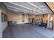 A spacious garage with gray epoxy flooring, white cabinets, and an assortment of tools and storage solutions at 10633 Tinta Ln, Las Vegas, NV 89144