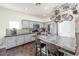 Bright kitchen featuring stainless appliances, gray cabinets, tiled backsplash, and spacious island with bar stool seating at 10633 Tinta Ln, Las Vegas, NV 89144