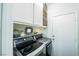 Well-organized laundry room featuring modern washer and dryer units, overhead cabinets and decorative shelves at 10633 Tinta Ln, Las Vegas, NV 89144