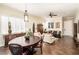Comfortable living room with an adjacent dining area featuring wood floors, neutral paint, and stylish furnishings at 10633 Tinta Ln, Las Vegas, NV 89144