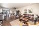 Open-concept living room and kitchen area with hardwood floors and neutral color palette at 10633 Tinta Ln, Las Vegas, NV 89144