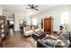 Cozy living room with rich wood floors, neutral paint, ceiling fan, and comfortable seating arrangement at 10633 Tinta Ln, Las Vegas, NV 89144