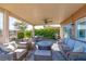 Inviting outdoor patio area with comfortable seating, fire pit, BBQ grill and lush green landscaping at 10633 Tinta Ln, Las Vegas, NV 89144