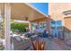 Inviting outdoor patio area with comfortable seating, fire pit, garden decor and drought resistant landscaping at 10633 Tinta Ln, Las Vegas, NV 89144
