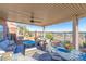 Covered patio with desert view, comfortable seating, fire pit and dining table creating an inviting outdoor space at 10633 Tinta Ln, Las Vegas, NV 89144