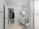 Well-lit bathroom features white vanity, large mirror, and tiled shower enclosure at 10725 Bernini Dr, Las Vegas, NV 89141