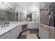 Bright bathroom featuring a spacious vanity with dual sinks and a glass-enclosed shower with tile surround at 10725 Bernini Dr, Las Vegas, NV 89141