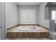 Relaxing bathroom with a luxurious soaking tub and plantation shutters for a spa-like experience at 10725 Bernini Dr, Las Vegas, NV 89141