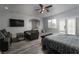 An open bedroom featuring a sitting area and a dark-toned wood floor at 10725 Bernini Dr, Las Vegas, NV 89141