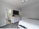 Bedroom with a large window, ceiling fan, dresser, and adjacent bathroom at 10725 Bernini Dr, Las Vegas, NV 89141