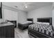 A contemporary bedroom with two beds, grey walls, and wood-look floors at 10725 Bernini Dr, Las Vegas, NV 89141