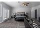 Large primary bedroom with a sitting area, wood-look floors and a ceiling fan at 10725 Bernini Dr, Las Vegas, NV 89141