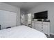 Well-lit bedroom with wood floors and a bathroom in the background at 10725 Bernini Dr, Las Vegas, NV 89141