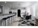 Eat-in kitchen with stainless steel appliances, granite countertop bar, and stylish dining area with modern chandelier at 10725 Bernini Dr, Las Vegas, NV 89141