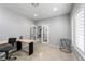 Bright home office featuring neutral walls, shuttered windows and glass French doors at 10725 Bernini Dr, Las Vegas, NV 89141
