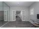 Bright home office with French doors, wood-look floors, and a large mirror at 10725 Bernini Dr, Las Vegas, NV 89141