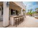 Spacious outdoor kitchen with bar seating and built-in grill, perfect for entertaining at 10725 Bernini Dr, Las Vegas, NV 89141