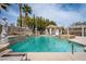 Gorgeous pool with multiple water features, lush landscaping, and inviting lounge areas at 10725 Bernini Dr, Las Vegas, NV 89141