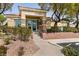 Inviting clubhouse exterior with stone accents, tiled roof, and attractive landscaping at 11253 Piper Peak Ln, Las Vegas, NV 89138