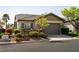 Inviting single-story home with a well-manicured front yard and an attached two-car garage at 11253 Piper Peak Ln, Las Vegas, NV 89138