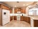 Well-equipped kitchen with stainless steel appliances, wood cabinetry, and tile flooring at 11253 Piper Peak Ln, Las Vegas, NV 89138