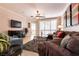 Comfortable living room featuring a large sectional sofa, ceiling fan, and modern decor at 11253 Piper Peak Ln, Las Vegas, NV 89138