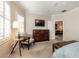 Main bedroom with a TV, dresser, and an open doorway to a lounge room at 11253 Piper Peak Ln, Las Vegas, NV 89138