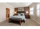 Relaxing main bedroom with a king bed, elegant decor, and an en-suite bathroom at 11253 Piper Peak Ln, Las Vegas, NV 89138