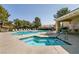 Resort-style pool area with hot tub, multiple lounge chairs, and clear pool rules posted at 11253 Piper Peak Ln, Las Vegas, NV 89138