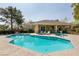 Sparkling pool surrounded by lounge chairs and lush landscaping for relaxation at 11253 Piper Peak Ln, Las Vegas, NV 89138
