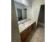 Bathroom featuring a wide mirror, vanity with sink, and a tiled floor at 1209 Equator Ave, North Las Vegas, NV 89032