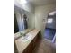 Bathroom featuring a large mirror, vanity with sink, and tile flooring at 1209 Equator Ave, North Las Vegas, NV 89032