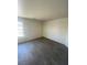 An empty bedroom featuring modern floors and a bright window at 1209 Equator Ave, North Las Vegas, NV 89032