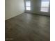 An empty bedroom featuring modern floors and bright windows at 1209 Equator Ave, North Las Vegas, NV 89032