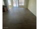 Open-concept living room featuring wood flooring, sliding glass doors, and lots of natural light at 1209 Equator Ave, North Las Vegas, NV 89032