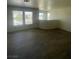 Living room with modern floors and large windows with natural light at 1209 Equator Ave, North Las Vegas, NV 89032