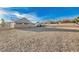 Wide shot of a backyard with desert landscaping and a view of neighboring houses at 1319 Highland Ct, Boulder City, NV 89005