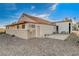 Back view of a home featuring desert landscaping, a brick wall and an attached garage at 1319 Highland Ct, Boulder City, NV 89005