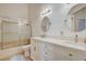 Bright bathroom with dual vanity, framed mirrors, modern fixtures, and a glass-enclosed shower at 1319 Highland Ct, Boulder City, NV 89005