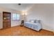 Cozy bedroom featuring parquet floors, a built-in bookcase, and a window with light-filtering shutters at 1319 Highland Ct, Boulder City, NV 89005