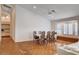 Bright dining area featuring hardwood floors, a large window with shutters, and a built-in bench at 1319 Highland Ct, Boulder City, NV 89005