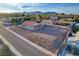 Expansive desert property featuring a single-story home with a low-pitched red-tiled roof, ample space, and mountain views at 1319 Highland Ct, Boulder City, NV 89005