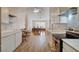 Open kitchen featuring white cabinets, quartz countertops, stainless steel appliances, and an adjoining dining area at 1319 Highland Ct, Boulder City, NV 89005
