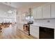 Bright kitchen features white cabinetry, stainless steel appliances, and tile flooring at 1319 Highland Ct, Boulder City, NV 89005