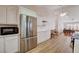 Spacious kitchen featuring stainless steel appliances, white cabinets, and open layout to dining area at 1319 Highland Ct, Boulder City, NV 89005